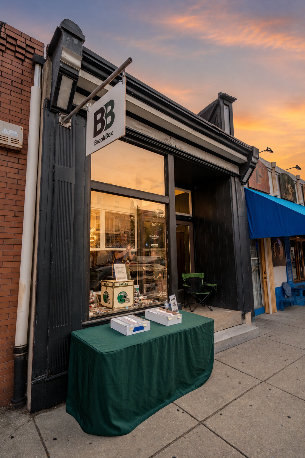 TheBreakBox sports card shop storefront on Main Street in Manayunk, Philadelphia at sunset